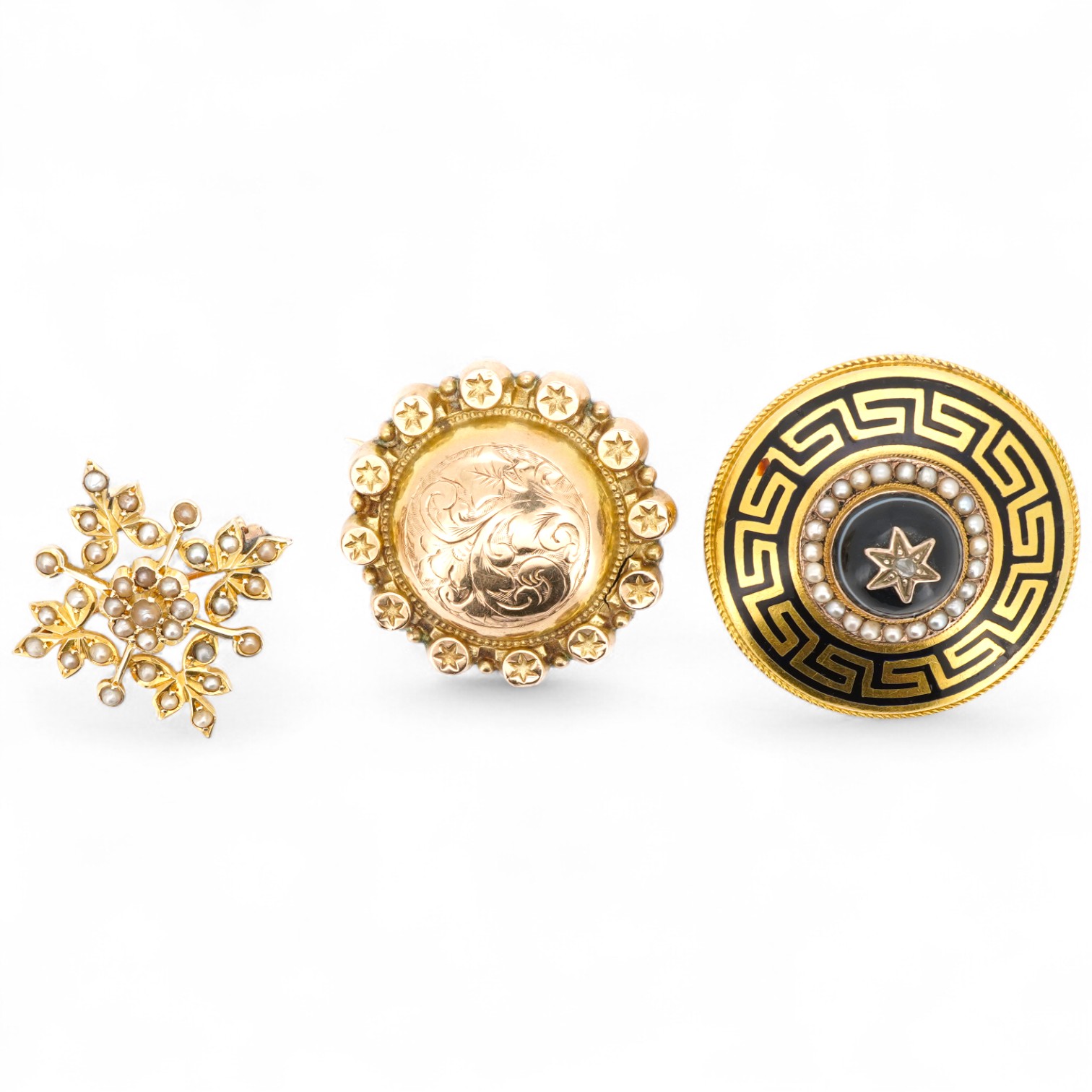 Three brooches, comprising: a Victorian circular brooch centring on a cabochon onyx set with a rose-cut diamond in a star setting, to concentring bands of seed pearls and Greek key motifs in black enamel, the reverse wit